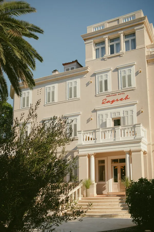 Hotel Zagreb façade framed by palms and olive trees