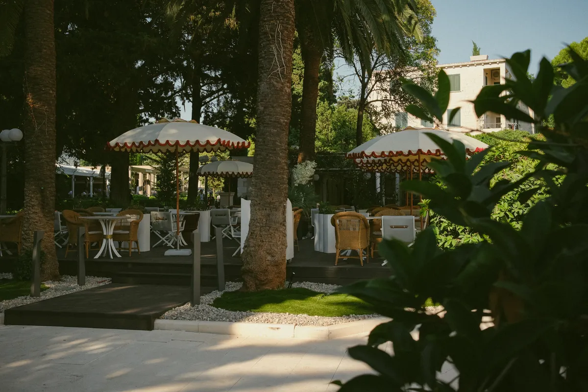 Garden terrace tables under scalloped parasols