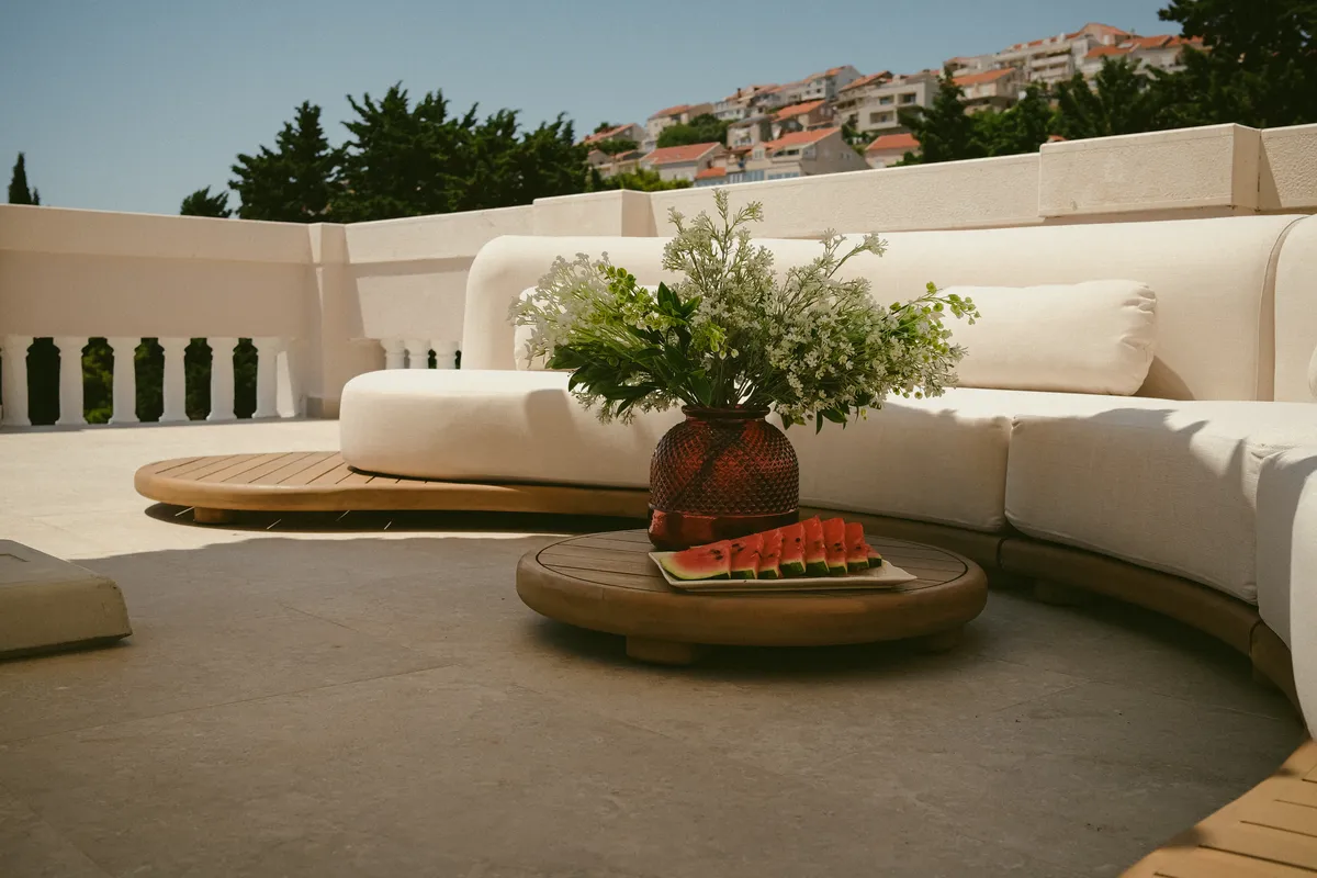 Rooftop terrace lounge with a curved sofa